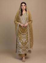 A highly detailed, unstitched Mustard Chiffon Embroidered Dress material featuring heavy, intricate white threadwork and subtle gold accents, laid flat with a matching embroidered dupatta/pallu piece above it. Includes raw silk trouser material