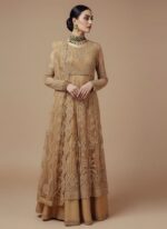 Pale yellow embroidered net sharara suit fabric laid flat, showing the heavily embellished shirt panels and borders for a formal Pakistani/Indian outfit.