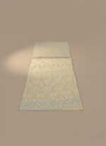 Pale yellow embroidered net sharara suit fabric laid flat, showing the heavily embellished shirt panels and borders for a formal Pakistani/Indian outfit.