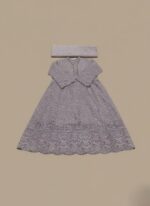 A flat lay image of a mauve embroidered net maxi dress with a short jacket-style bodice and a flowing skirt, accompanied by a matching plain mauve net dupatta, all laid out on a beige background.