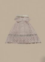 A flat lay image of a mauve embroidered net maxi dress with a short jacket-style bodice and a flowing skirt, accompanied by a matching plain mauve net dupatta, all laid out on a beige background.