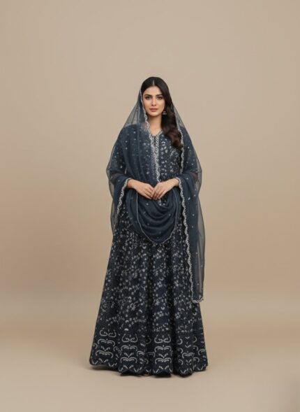 A flat lay image of a mauve embroidered net maxi dress with a short jacket-style bodice and a flowing skirt, accompanied by a matching plain mauve net dupatta, all laid out on a beige background.
