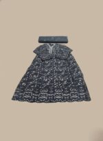 A flat lay image of a mauve embroidered net maxi dress with a short jacket-style bodice and a flowing skirt, accompanied by a matching plain mauve net dupatta, all laid out on a beige background.