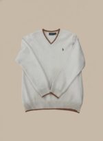 Men's beige V-neck sweater with brown striped trim on the collar, cuffs, and hem, worn by a model.