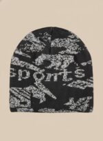 Image of a man wearing a black beanie with a grey abstract pattern and the word "SPORTS" knitted into the design.
