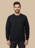 Men's black textured crew neck sweater with a subtle all-over pattern, displayed on a model, highlighting its classic appeal and comfortable fit.