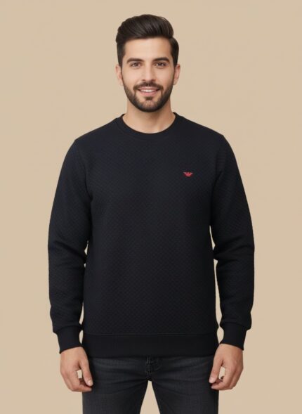 Men's black textured crew neck sweater with a subtle all-over pattern, displayed on a model, highlighting its classic appeal and comfortable fit.