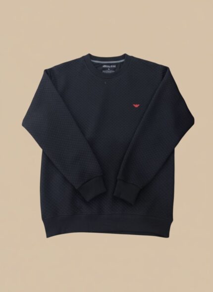 Men's black textured crew neck sweater with a subtle all-over pattern, displayed on a model, highlighting its classic appeal and comfortable fit.