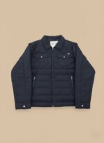 Men's dark blue puffer jacket, lightweight quilted winter coat with full zip and chest pockets on a light background.