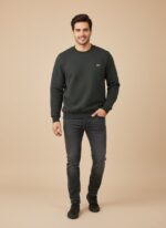 Men's dark grey textured crew neck sweater with a subtle chevron pattern, worn by a model, showcasing its fit and sophisticated dark grey color.
