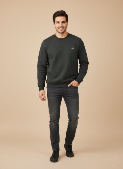 Men's dark grey textured crew neck sweater with a subtle chevron pattern, worn by a model, showcasing its fit and sophisticated dark grey color.