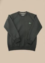 Men's dark grey textured crew neck sweater with a subtle chevron pattern, worn by a model, showcasing its fit and sophisticated dark grey color.