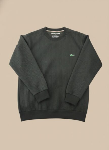 Men's dark grey textured crew neck sweater with a subtle chevron pattern, worn by a model, showcasing its fit and sophisticated dark grey color.