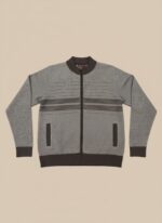 A man wearing a men's grey full zip sweater with dark brown horizontal stripes and dark pants, standing against a neutral background.