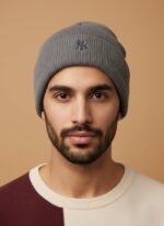 Men's grey knit beanie with an embroidered logo on a neutral background, a warm and stylish winter hat accessory.