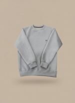 Men's light grey textured crew neck sweater on a model, highlighting the subtle pattern and relaxed fit of the light grey pullover.