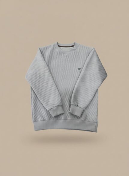 Men's light grey textured crew neck sweater on a model, highlighting the subtle pattern and relaxed fit of the light grey pullover.