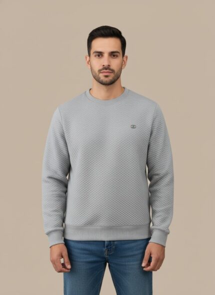 Men's light grey textured crew neck sweater on a model, highlighting the subtle pattern and relaxed fit of the light grey pullover.