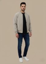 Light grey or beige men's lightweight bomber jacket with a full silver zip closure and two zippered side pockets, displayed flat against a complementary background.