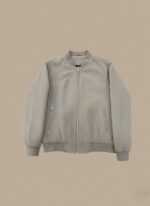 Light grey or beige men's lightweight bomber jacket with a full silver zip closure and two zippered side pockets, displayed flat against a complementary background.