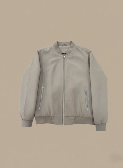 Light grey or beige men's lightweight bomber jacket with a full silver zip closure and two zippered side pockets, displayed flat against a complementary background.