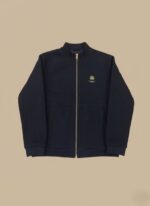 Men's navy zip-up jacket with gold zipper and chest logo on a light background.