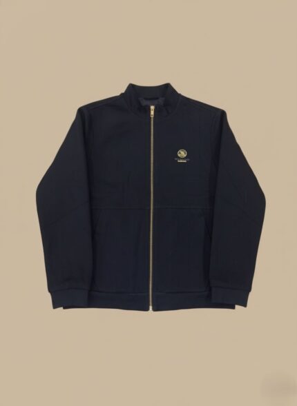 Men's navy zip-up jacket with gold zipper and chest logo on a light background.