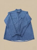 Men's blue flannel shirt, long sleeve, button-up, with two chest pockets, folded on a neutral background.