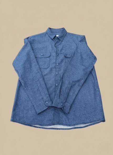 Men's blue flannel shirt, long sleeve, button-up, with two chest pockets, folded on a neutral background.