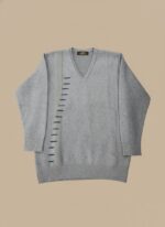 Men's Grey V-Neck Sweater with vertical blue stripe details, worn by a man with dark hair, posing against a light brown background.