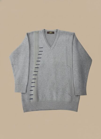 Men's Grey V-Neck Sweater with vertical blue stripe details, worn by a man with dark hair, posing against a light brown background.