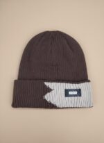 Image of a man wearing a brown and light grey/beige two-tone ribbed beanie with a black "DESIGN" tag on the fold.