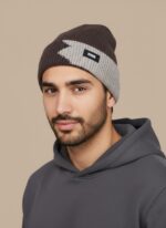 Image of a man wearing a brown and light grey/beige two-tone ribbed beanie with a black "DESIGN" tag on the fold.