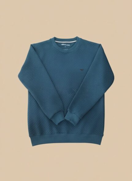 Men's teal textured crew neck sweater with a diamond-like pattern, displayed on a model, highlighting the vibrant color and soft material.