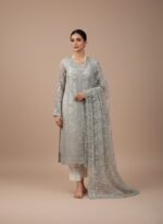 NUREH The Royal Palace NL-42 Carmela Unstitched Luxury Formals Embroidered Organza Suit in light grey, with silver hand embroidery and mukesh work on organza shirt and sleeves, embroidered organza zari dupatta, and raw silk trousers, worn by a female model.