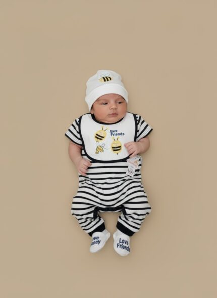 A newborn baby wearing a black and white striped romper, a "Bee Friends" bib, a white bee-embroidered beanie, and "Love Friends" socks from the 5-piece Baby Bee Friends outfit set.