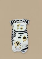 A newborn baby wearing a black and white striped romper, a "Bee Friends" bib, a white bee-embroidered beanie, and "Love Friends" socks from the 5-piece Baby Bee Friends outfit set.