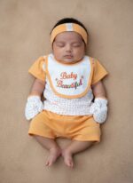 Soft and breathable newborn baby clothing set featuring six coordinated cotton pieces in peach-orange tones. Perfect for everyday wear or gifting newborns.