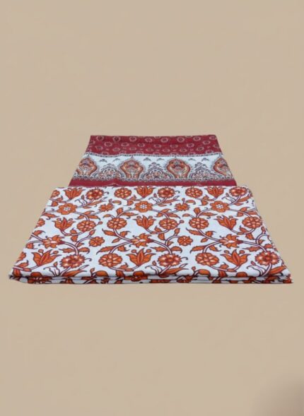 Palwasha floral print 3 PC unstitched lawn fabric suit on a wooden table, showcasing the intricate patterns of the shirt and dupatta pieces, with a product box in the background.