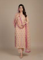 Peach and magenta hand-painted cotton fabric, unstiched with floral patterns and sequins.