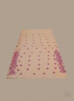 Peach and magenta hand-painted cotton fabric, unstiched with floral patterns and sequins.