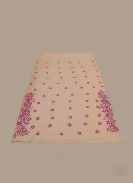 Peach and magenta hand-painted cotton fabric, unstiched with floral patterns and sequins.