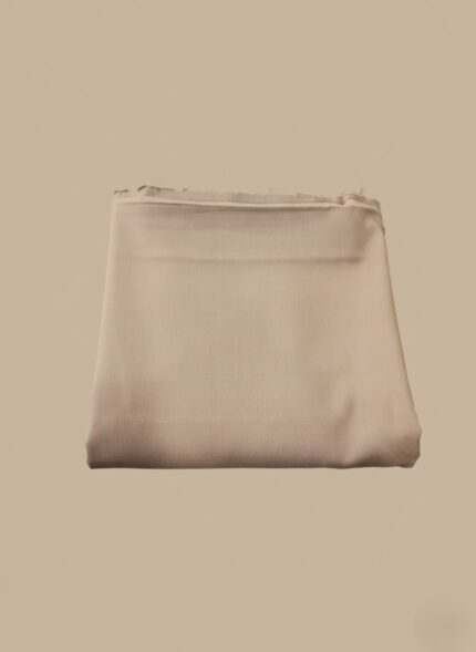 Folded premium beige cotton fabric, soft and ready for sewing projects like a sweater or other apparel.
