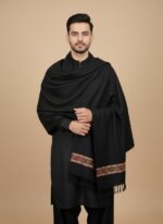 Black men's shawl with colorful embroidered stripe, folded neatly on a light background.