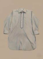 Boy wearing a grey kameez with embroidered placket and full sleeves; additional flat-lay image of the boys grey kameez on beige background.