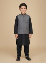 Child wearing a black boys kurta waistcoat set with a grey waistcoat, along with a flat-lay of the complete outfit.
