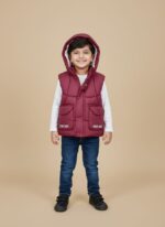 Young boy wearing a maroon hooded kids' puffer vest with "PLEASE SMILE" text, a warm sleeveless jacket.