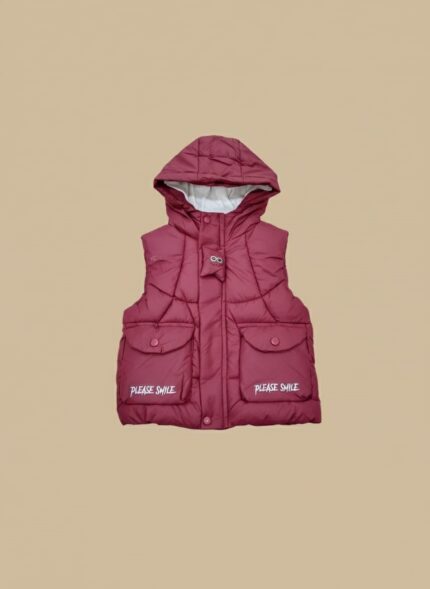 Young boy wearing a maroon hooded kids' puffer vest with "PLEASE SMILE" text, a warm sleeveless jacket.