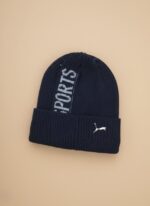 Puma Men's Navy Blue Winter Sports Beanie Cap with grey "SPORTS" stripe and white Puma logo embroidery on ribbed knit fabric.