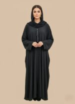 Neutral woman abaya in soft crepe, open-front kimono sweater style, side pockets and belt shown on model against light studio backdrop